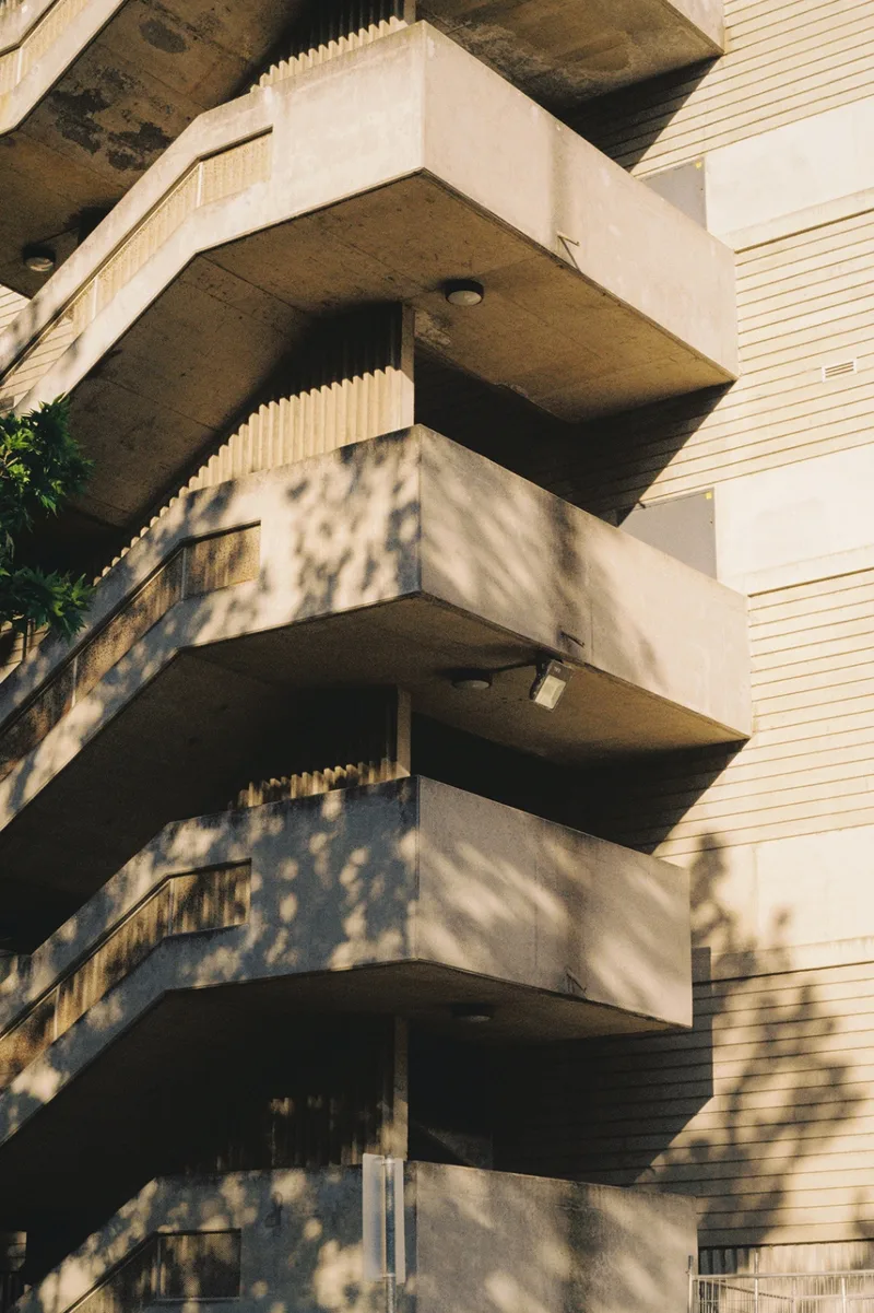architecture that doesn't try to be pretty, just tries to endure. shot on Kodak Gold 200 with a Pentax Spotmatic II, developed at Halide Express, by journey with goran