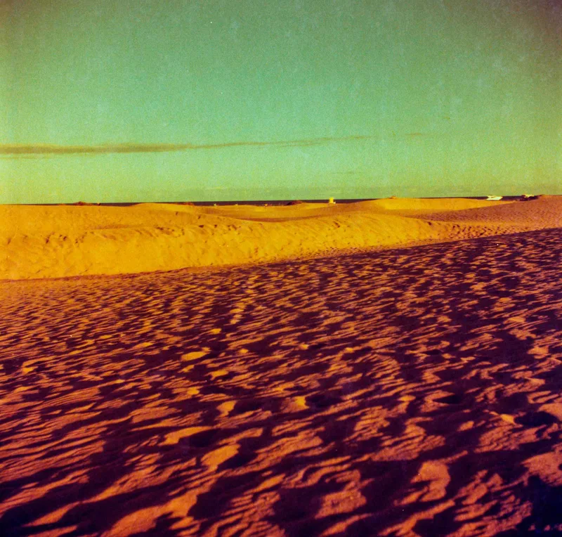 Redscaled dune in Maspalomas shot on Lomography Redscale XR 50-200 with a Ricoh RicohflexDiacordG, developed at SuperFoto, by Herkus
