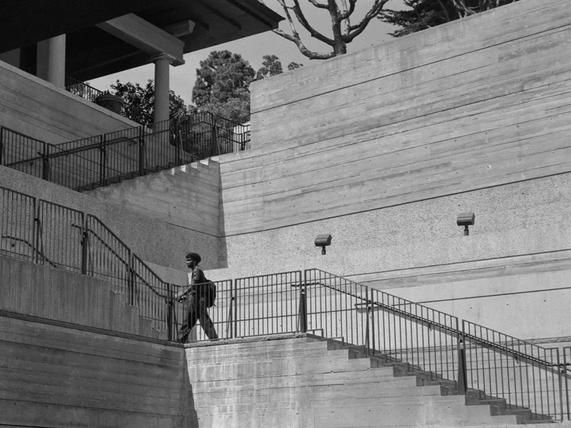 Man walking shot on Kodak T-Max 400 with a Canon P, developed at The DarkRoom, by Paper Image