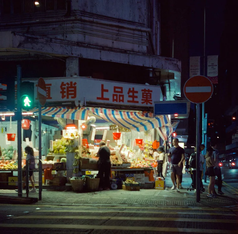 fruit stall at night shot on Cinestill 800T with a Yashica D, developed at Dotwell Photo, by Prima Chan
