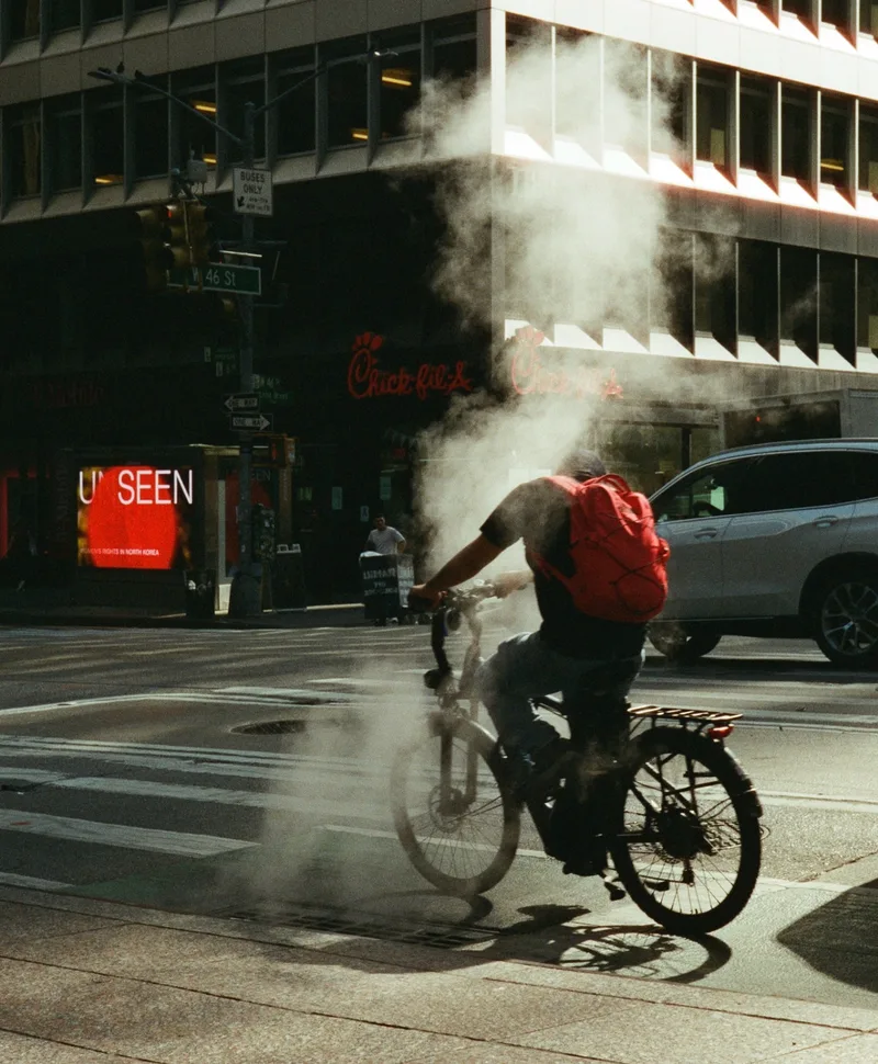 A man on a bicycle shot on Cinestill 400D with a Leica M6, developed at Gelatin Labs, by Thomas