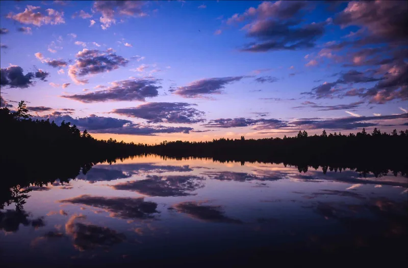 Sunset over a lake shot on Fujifilm Provia 100F with a Fuji GSW690II, by Sven