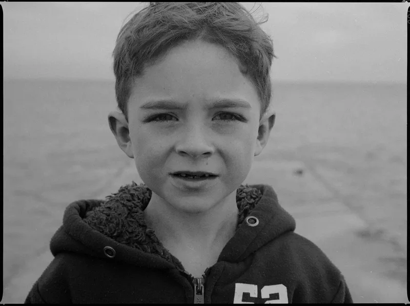 Portrait d’Aïdan au bout de la cale shot on Lomography CN 100 with a Mamiya 645 1000S, developed at L'Atelier Argentique, by Analogue Resistance