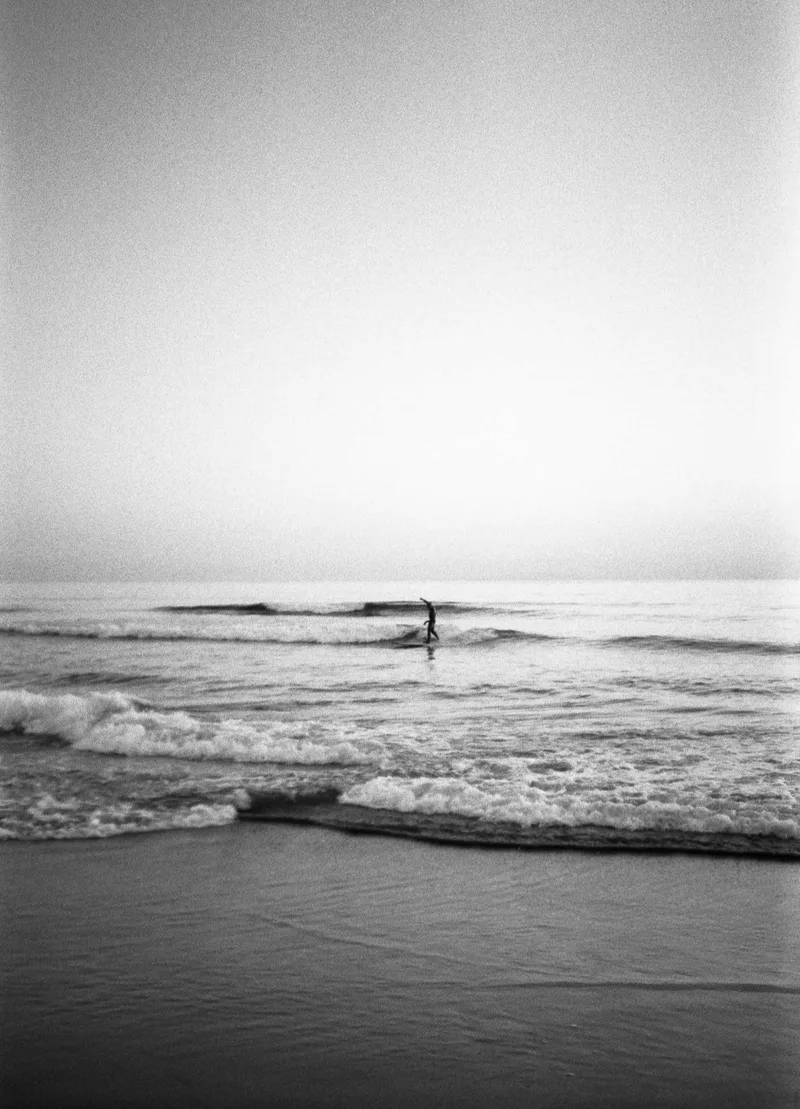 Sunset Surfer shot on Ilford Kentmere Pan 400 with a Yashica T3, developed at On Film Lab, by Eikesoeren