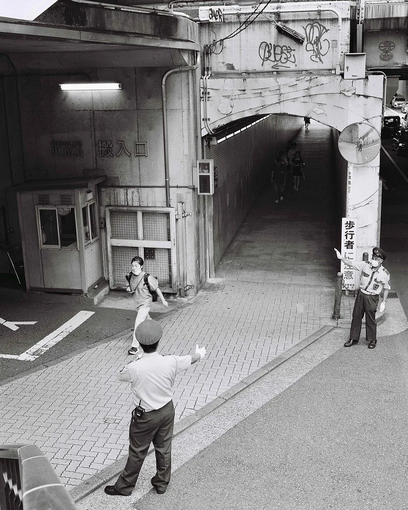 Directing Traffic shot on Ilford Kentmere Pan 400 with a Bronica RF645, developed at Bic Camera Shinjuku, by Nicholas Smith