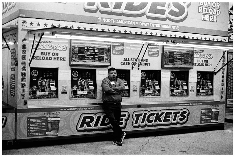 Waiting to help you buy tickets shot on Kodak Tri-X 400 with a Canon F-1, developed at Not Another Film Lab, by Carlos Mas Jr