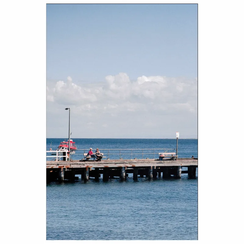 Couple on the pier shot on Kodak Portra 160 with a Minolta XG-M, developed at Work in Process, by Will Johns