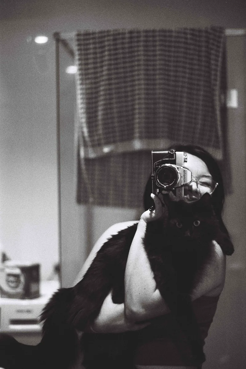 bathroom selfie shot on Ilford HP5 Plus 400 with a Minolta SR-T 101, developed at Film Never Die, by mari