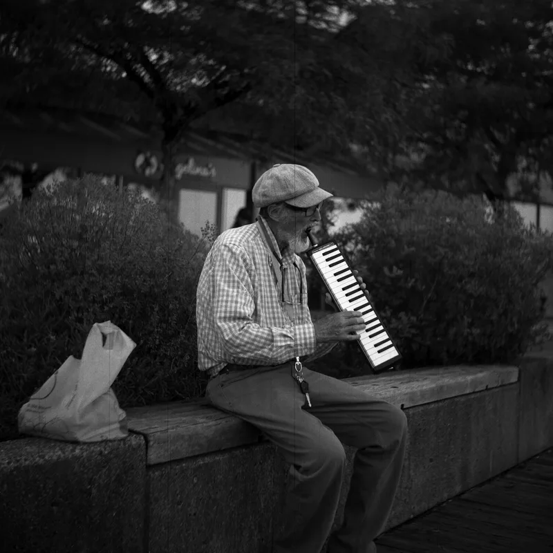 Waterfront Busker shot on Ilford HP5 Plus 400 with a Seagull 4B-1, developed at The Lab Vancouver, by Kryptexz
