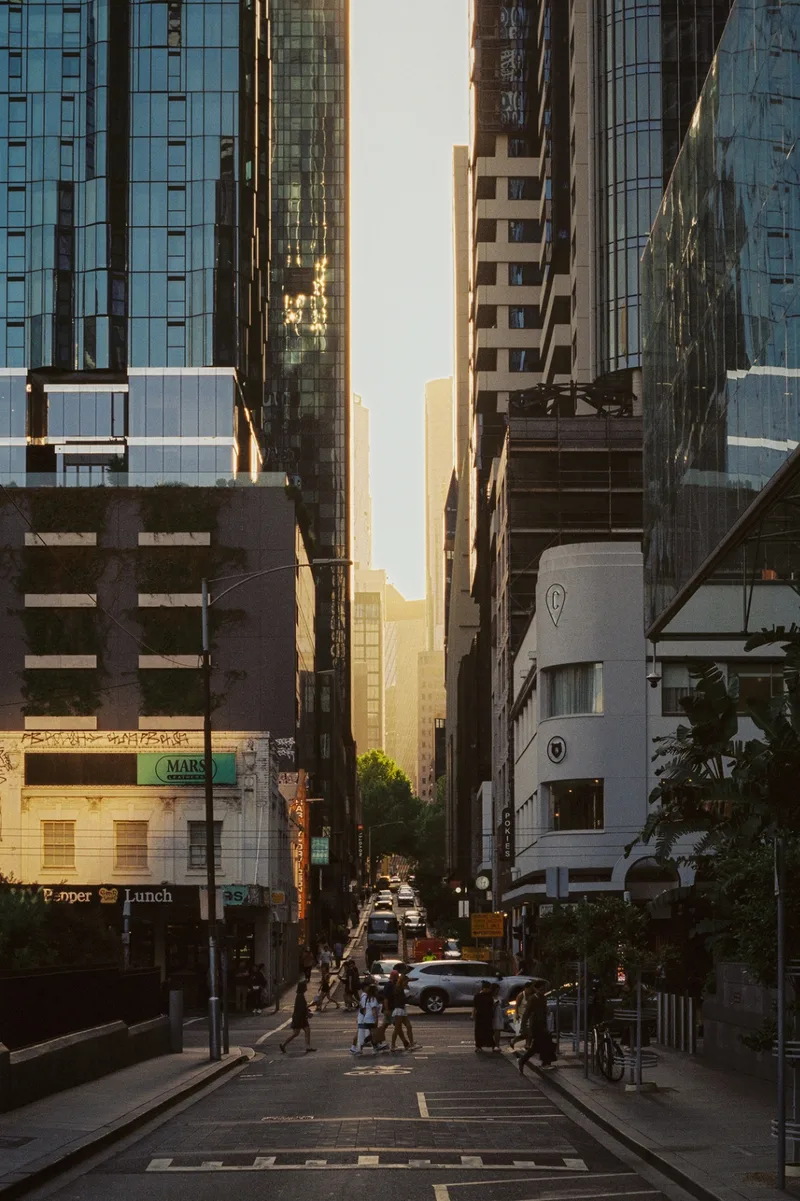 people passing through a canyon of glass and light. shot on Kodak Vision3 250D with a Pentax Spotmatic II, developed at Halide Express, by journey with goran
