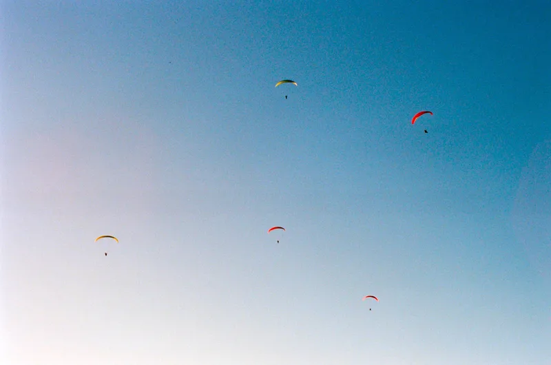 Paragliders at Sunset shot on Kodak Portra 400 with a Minolta Maxxum 7000, developed at Shot on Film Store, by Jacob Malpocker